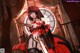 A woman in a red and black dress holding a sword.