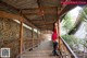 A woman in a red dress is walking up some stairs.