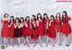 A group of women in red dresses posing for a picture.