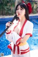 A woman in a red and white outfit holding a sword.